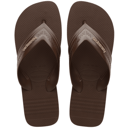dark brown sandals with rice pattern and grooves, with brown straos with a lighter brown stitched-look detailing, top view
