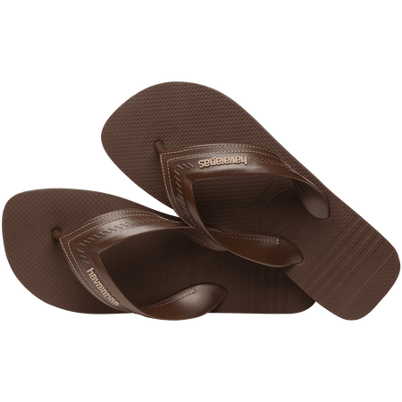 dark brown sandals with rice pattern and grooves, with brown straos with a lighter brown stitched-look detailing, both shoes leaning to the side, top view