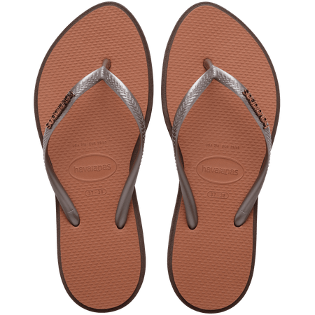 brown sandals with a dark brown outline around the footbed and metallic brown straps with a metal brown havaianas logo, top view