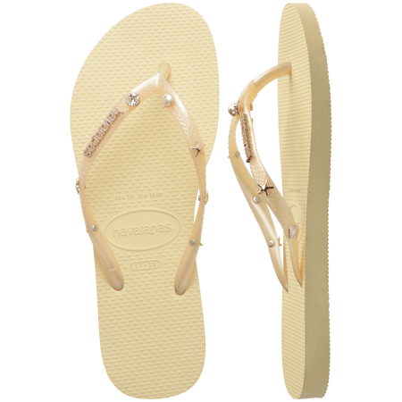 light yellow/buttercream sandals with yellow straps and crystals and pearls and star charms adorning the straps, one shoe top view one shoe side view