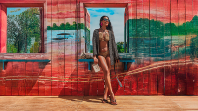 girl in flip flops with clutch on colorful background