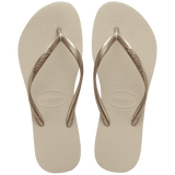 Women's beige flip flops with gold straps, top view