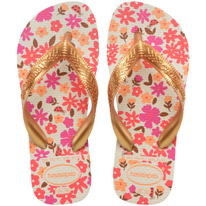 Floral patterned Havaianas flip flops with gold straps on a white background