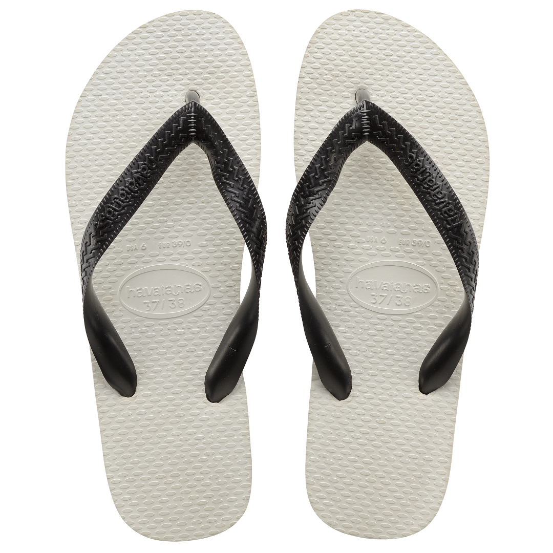 Pair of white flip flops with black straps on a transparent background
