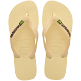 light yellow flip flops with yellow straps that say havaianas in brown, and a brazil flag, top view