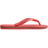 coral pink flip flops with pink straps that feature a small brazil flag, side view