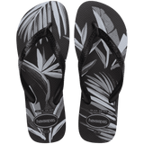A pair of men's Aloha flip flops with a tropical-themed print in black and white.