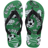 Pair of kids' Havaianas Top Athletic flip-flops featuring black textured straps and a green footbed decorated with soccer-themed graphics. The design includes soccer balls, cleats, whistles, goal nets, and the word "GOOOL" in bold lettering. The sandals have a lightweight green sole and embossed Havaianas branding on the straps and footbed.