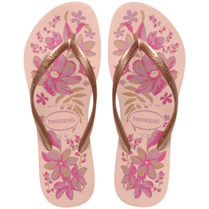 Pair of pink floral flip flops with brown straps and Havaianas logo on a white background