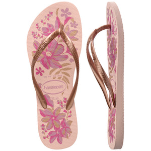 Pair of pink floral flip flops with brown straps and Havaianas logo on a white background, with left shoe in focus