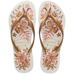 Pair of Havaianas flip flops with floral design and gold straps on a white background