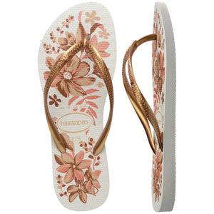 Pair of Havaianas flip flops with floral design and gold straps on a white background, with left shoe in focus