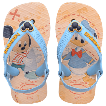 baby sandals with mickey mouse and donald duck on a yellow background with blue straps and a mickey mouse charm, top view