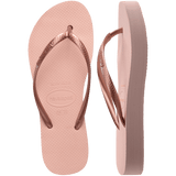 Pair of pink flip flops with a metallic strap, with left shoe in focus, on a transparent background