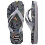 Kids' Havaianas Minecraft flip-flop shown in top and side views. The sandal features white textured straps with a black Havaianas logo, a white sole, and a gray footbed decorated with Steve, Alex, the Ender Dragon, pixelated swords, and Minecraft-themed icons.