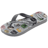 Flip flops with Minecraft blocks on a grey background, mix of green, yellow, pink, blocks and grey straps, front left view