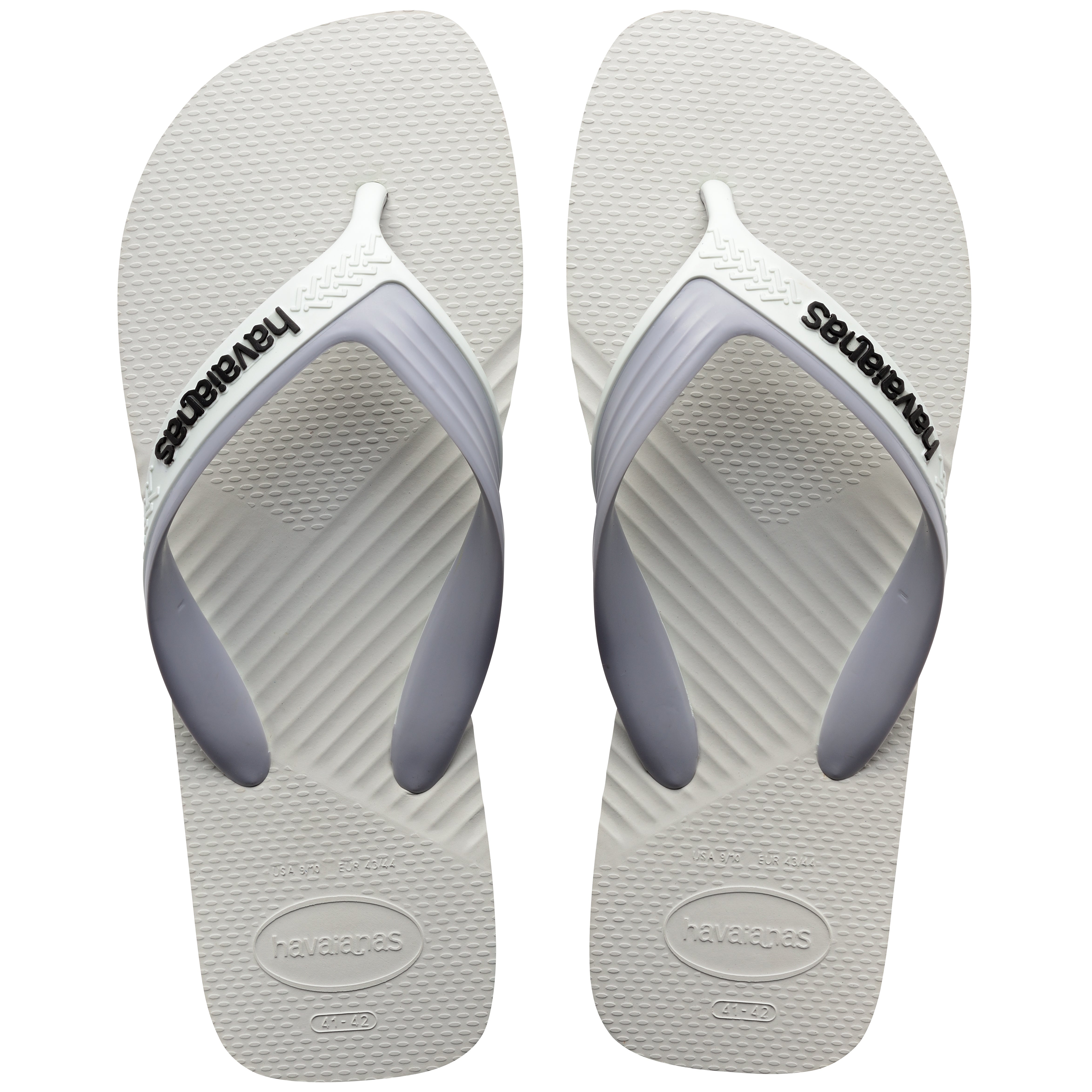 Pair of white Havaianas flip flops on a white background