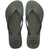 Pair of green glitter flip flops with Havaianas logo on a white background