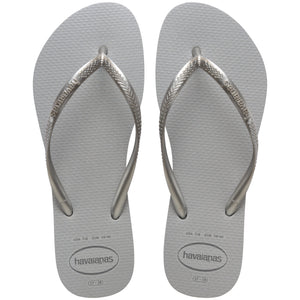 Pair of grey glitter flip flops with Havaianas logo on a white background