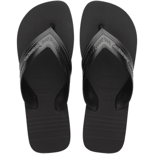 black sandals with rice patterned grooves and striped grooves on the footbed, with black straps and a grey stitched like pattern, top view