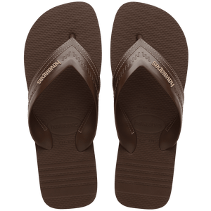 dark brown sandals with rice pattern and grooves, with brown straos with a lighter brown stitched-look detailing, top view