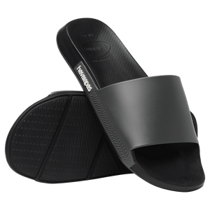 women's black slides bottom view of black sole with right shoe perched on top