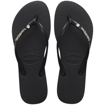 Pair of black Havaianas flip flops with a brand logo and a crystal detail on a white background