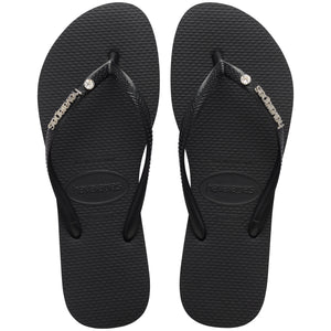 Pair of black Havaianas flip flops with a brand logo and a crystal detail on a white background