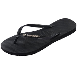 Single, left side, pair of black Havaianas flip flops and a crystal detail on a white background