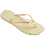 Single, right buttercream flip flop with a brand logo on a white background