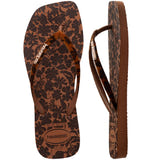 Flip-flops featuring a brown and black floral print and matching patterned straps, one shoe top view one shoe side view