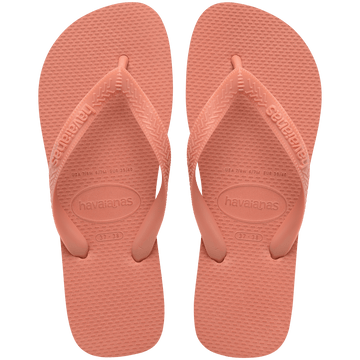 peach flip flops with rice pattern detail on sole and peach straps, top view