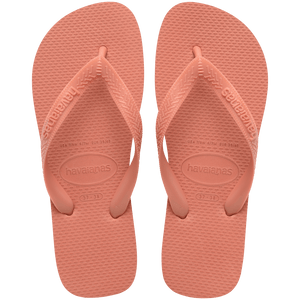 peach flip flops with rice pattern detail on sole and peach straps, top view