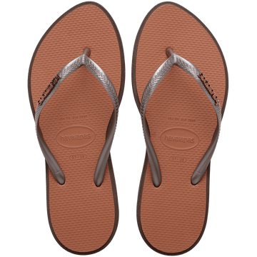 brown sandals with a dark brown outline around the footbed and metallic brown straps with a metal brown havaianas logo, top view