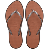 brown sandals with a dark brown outline around the footbed and metallic brown straps with a metal brown havaianas logo, top view