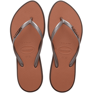 brown sandals with a dark brown outline around the footbed and metallic brown straps with a metal brown havaianas logo, top view