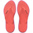 Pair of pink Havaianas flip flops with a  logo on the sole against a white background