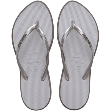 light grey sandals with darker grey outline around footbed, with metallic grey straps and a silver metal havaianas logo on the strap, top view