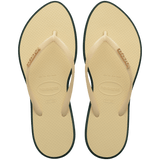 Women's cream pointed toe flip flops with dark green contrast sole top view
