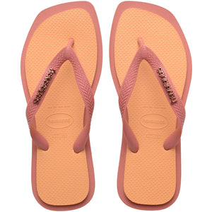 Pair of pink and orange Havaianas flip flops on a white background