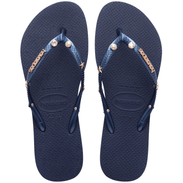 navy flip flops with navy straps adorned with pearl, crystal, and gold star charms and a gold metal havaianas logo, top view