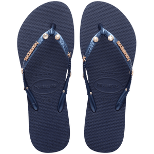 navy flip flops with navy straps adorned with pearl, crystal, and gold star charms and a gold metal havaianas logo, top view