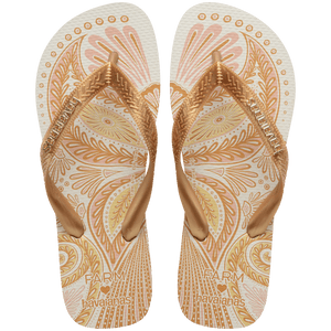 flip flops with gold and light pink abstract print and metallic gold straps with a metal havaianas logo, top facing
