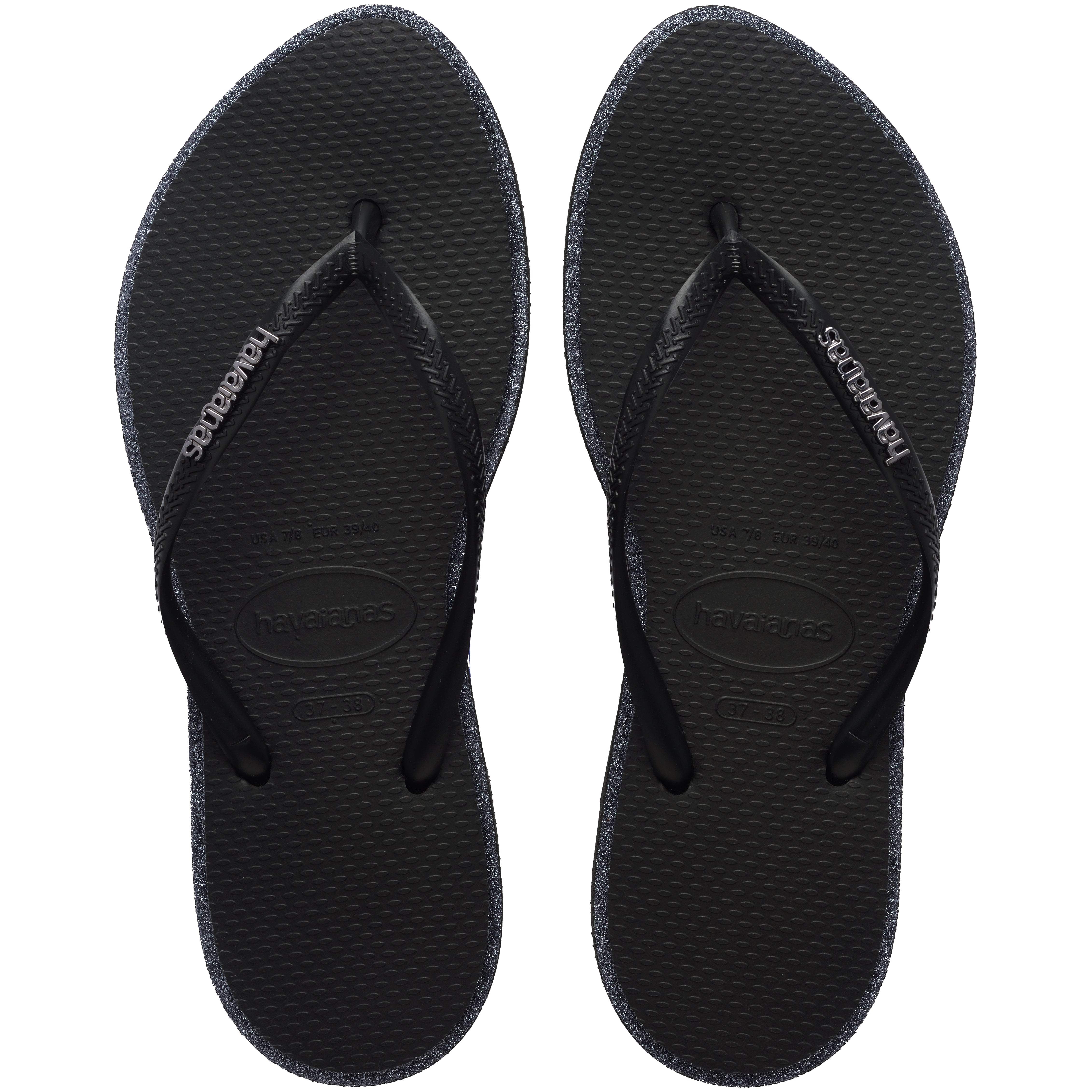 Pair of black Havaianas flip flop with glitter accent and black logo on the strap on a transparent background