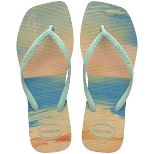 women's havaianas x gigi hadid square toe flip flops with blue and orange toned beach background top view