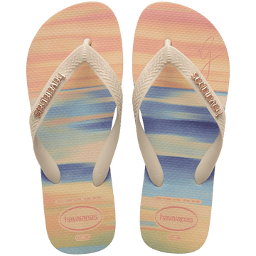 women's havaianas x gigi hadid flip flops with pink, orange, blue and green sunset print and a metallic havaianas logo on the straps, top view