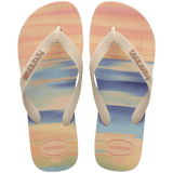 women's havaianas x gigi hadid flip flops with pink, orange, blue and green sunset print and a metallic havaianas logo on the straps, top view