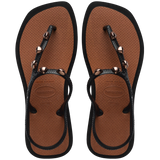 Top view of sandal with brown back straps, silver studs, and light brown sole