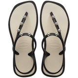 Top view of sandal with black back straps, silver studs, and white sole