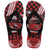 Pair of kids' Havaianas Disney Cars flip-flops with black straps and a red, black, and white racing-inspired print. The footbeds feature Lightning McQueen on one sandal and Mater on the other, accented with checkerboard graphics, bold typography, and Havaianas branding near the heel.